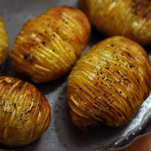 hasselback potatoes on a dish