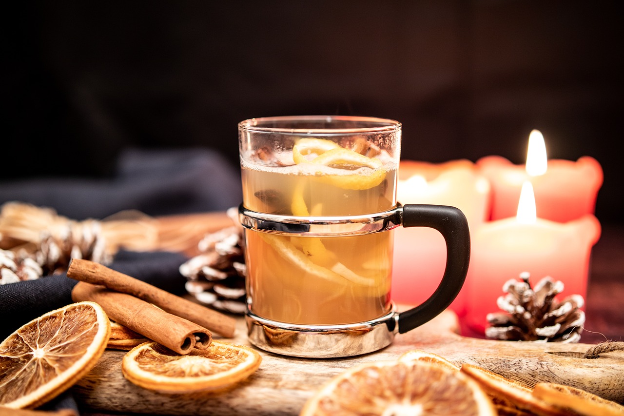 glass mug of warm cider with citrus slices