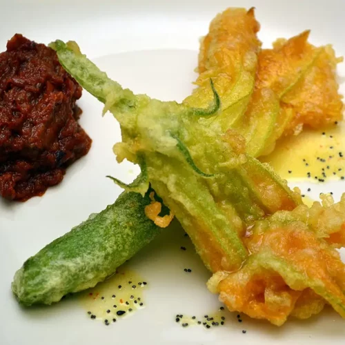 fried zucchini blossoms on a plate