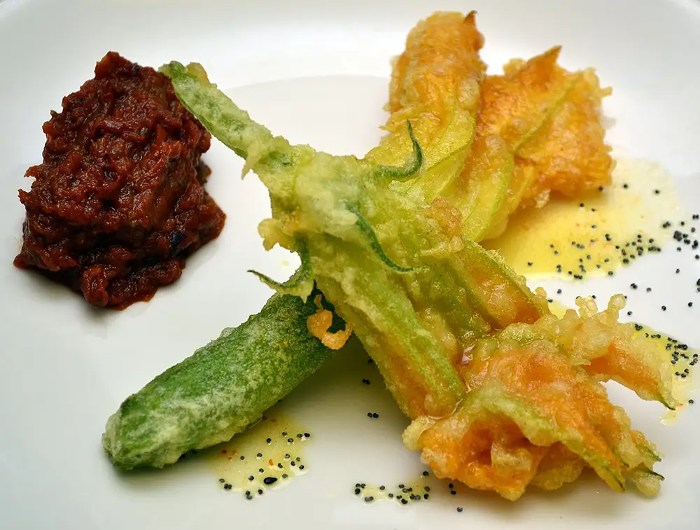 fried zucchini blossoms on a plate