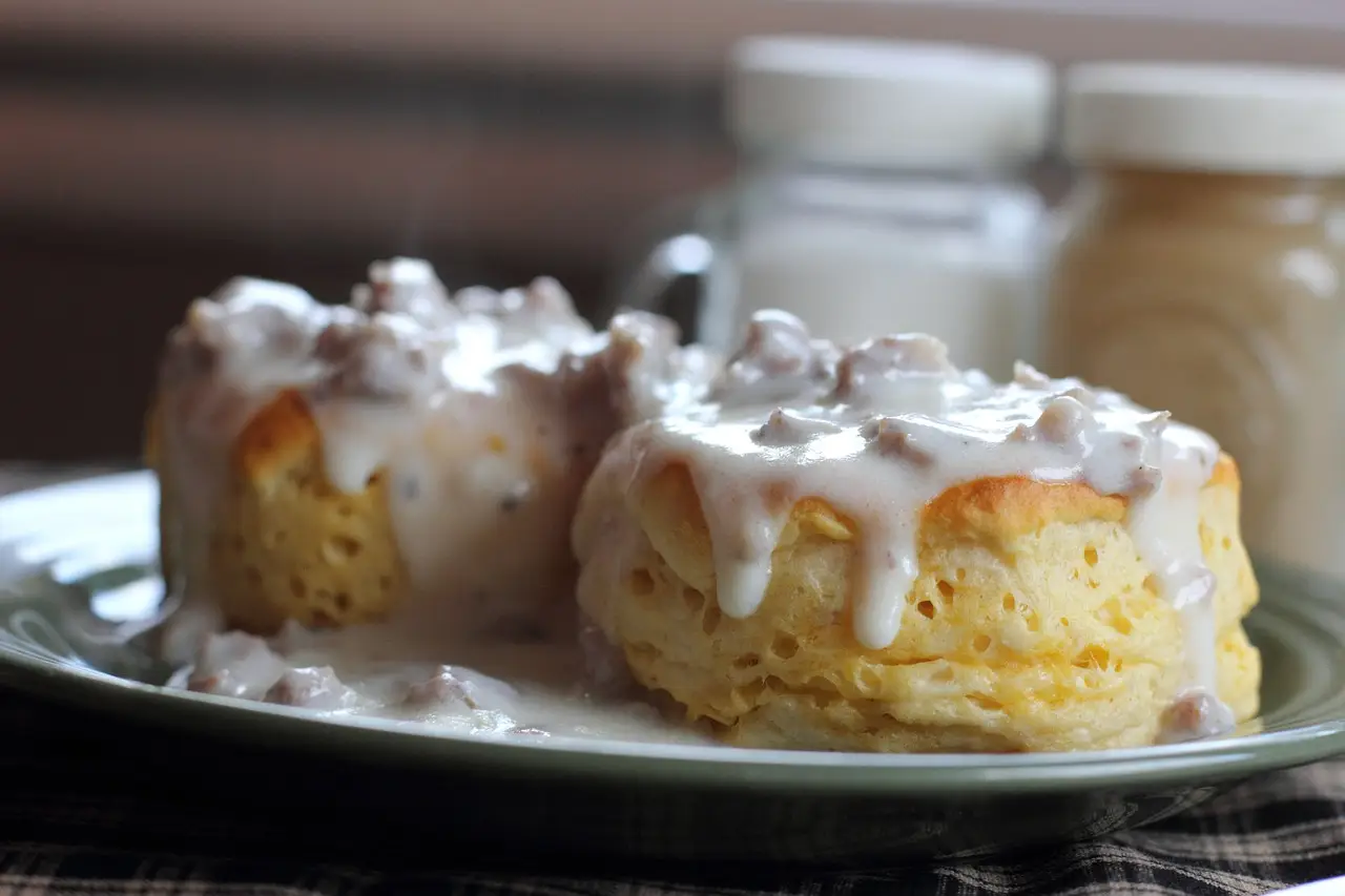 2 buttermilk biscuits covered in rich sausage gravy
