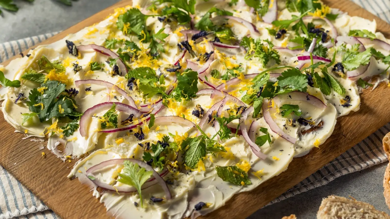butter board with red onion and fresh herbs
