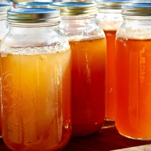 glass mason jars filled with amber fire cider