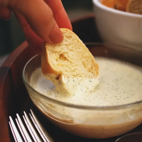 Bread dipped in creamy garlic aioli