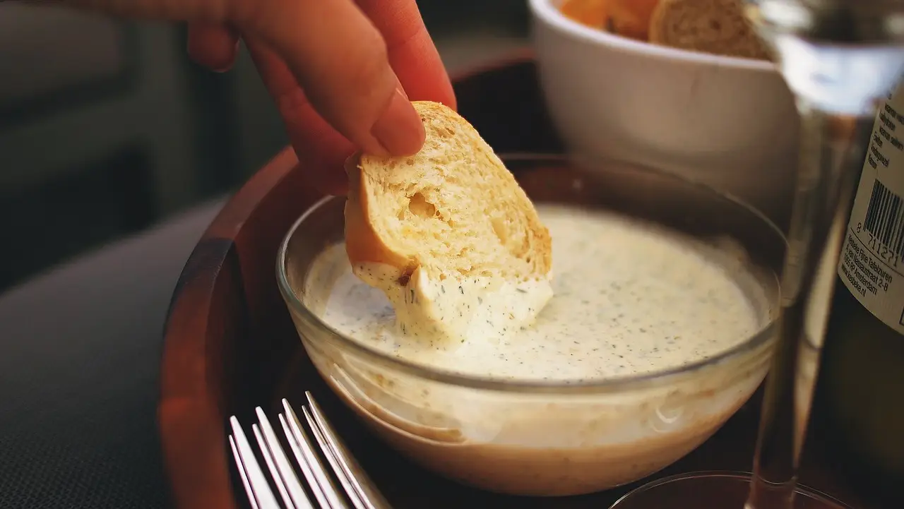 Bread dipped in creamy garlic aioli