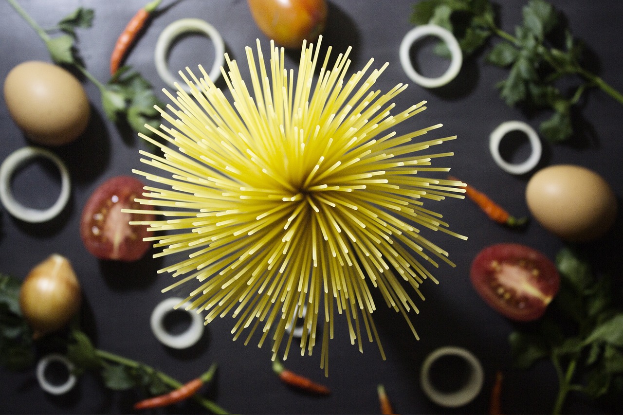 a swirl of pasta surrounded by veg