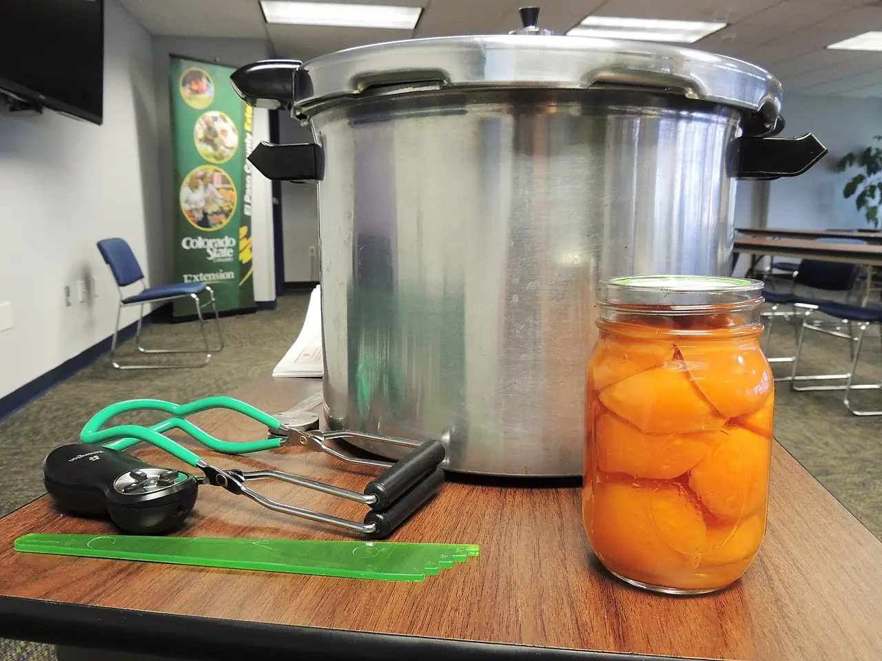 jar of peaches and canning supplies