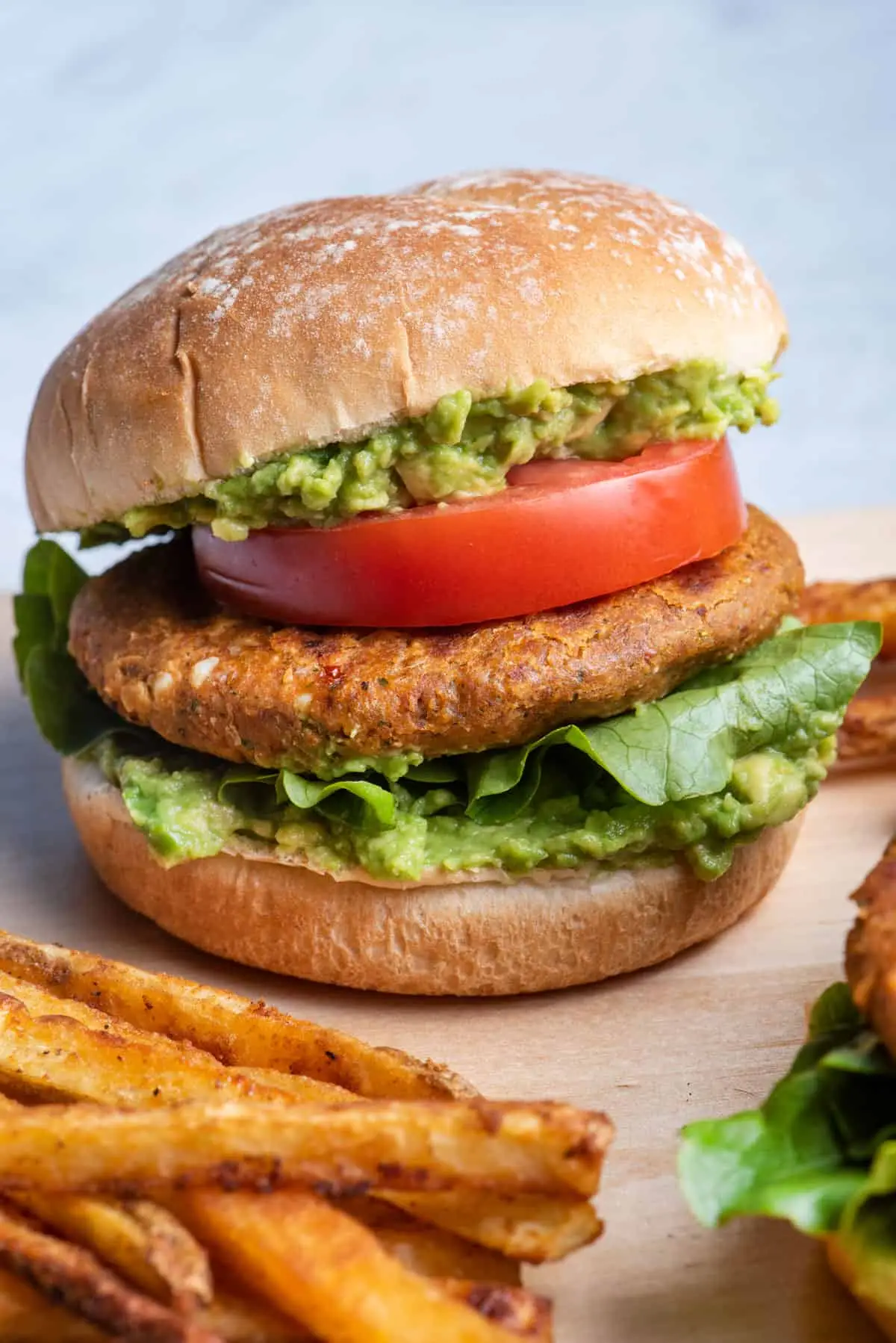 chickpea burger with tomato and lettuce on seeded roll