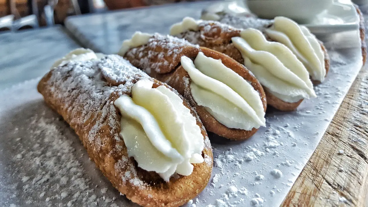 Cream-filled cannoli on a board