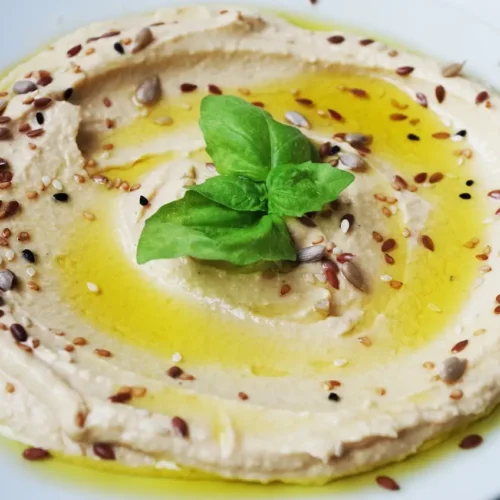 bowl of hummus drizzled with green olive oil