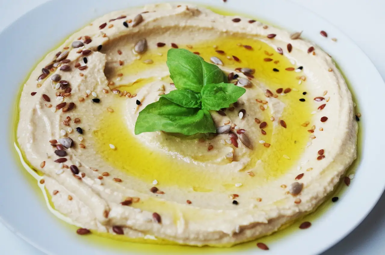 bowl of hummus drizzled with green olive oil