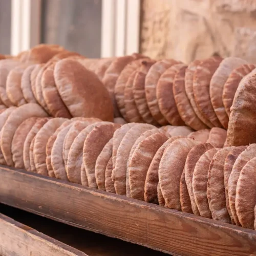 rows of fresh pita in a wooden trough