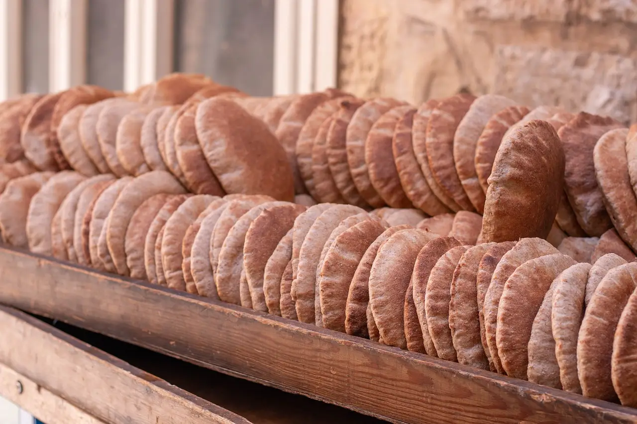 rows of fresh pita in a wooden trough