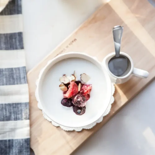 yogurt with fruit in a white bowl