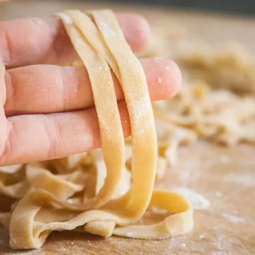 hand holding flat pasta