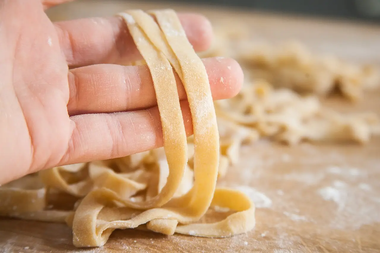 hand holding flat pasta